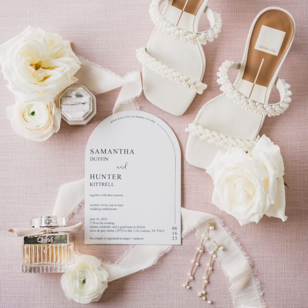 a white sandals with pearls and flowers. Photo by Bushel + Peck Photo, Texas Wedding Photographers