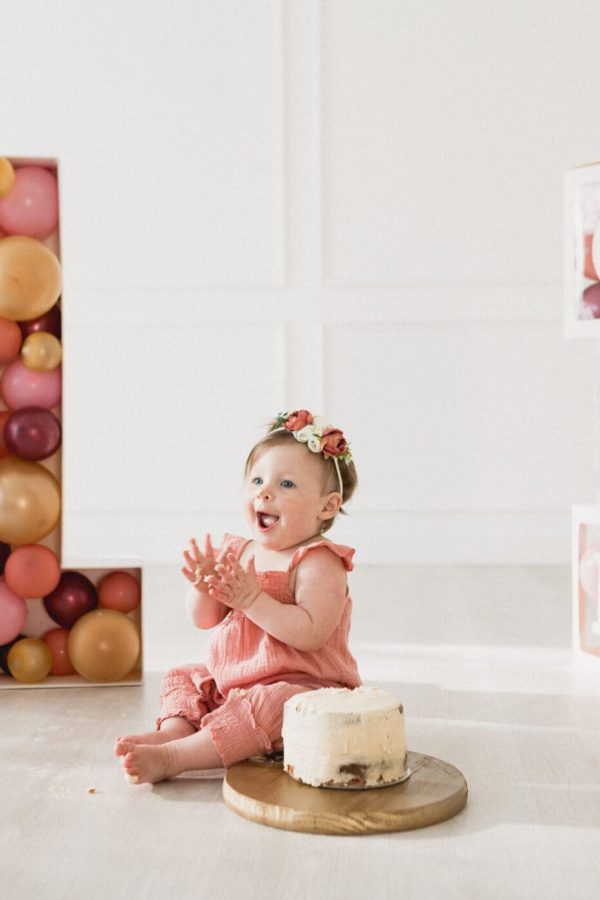 Bushel-Peck-Photo – Event Photography a baby sitting in front of a number and a cake. Event Photography By Bushel + Peck Photo