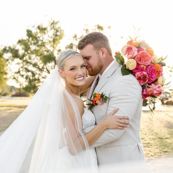Romantic wedding photography by Bushel + Peck Photo — bride and groom dancing outside elegant venue at sunset.