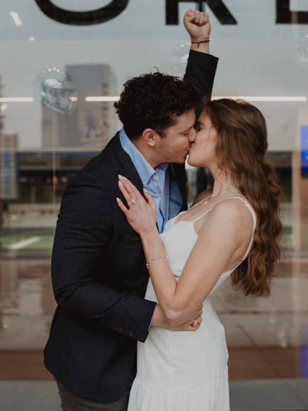 Evoto Couple celebrating engagement outside AT&T Stadium — Captured by Bushel + Peck Photo, Dallas Proposal Photographer